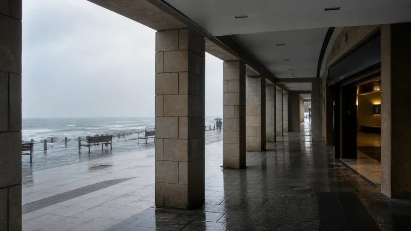 Paseo atlántico lluvioso visto desde soportales junto a un espacio cubierto