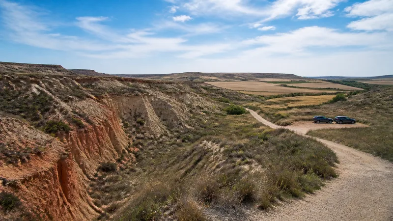 Barrancos de arcilla, matorral y campos en un paisaje semiárido